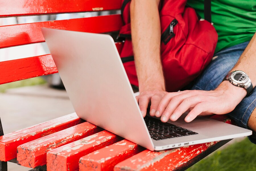 man-working-laptop-bench_23-2148205678