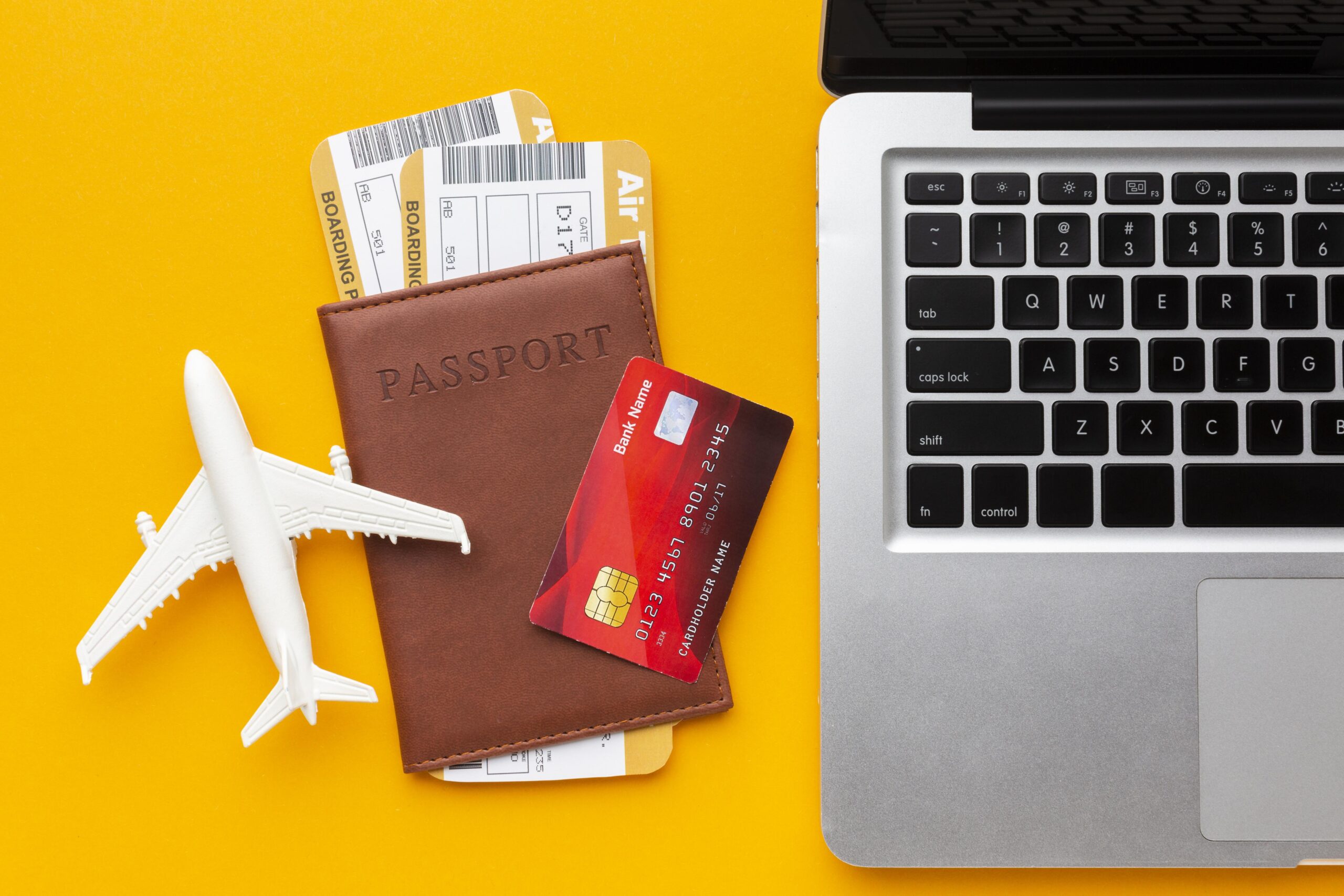 top-view-passport-laptop-arrangement