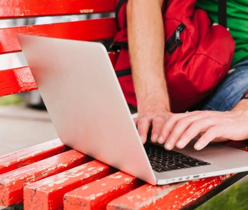 man-working-laptop-bench_23-2148205678